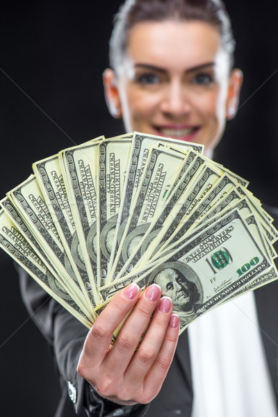 Businesswoman holding dollar banknotes Stock photo © LightFieldStudios
