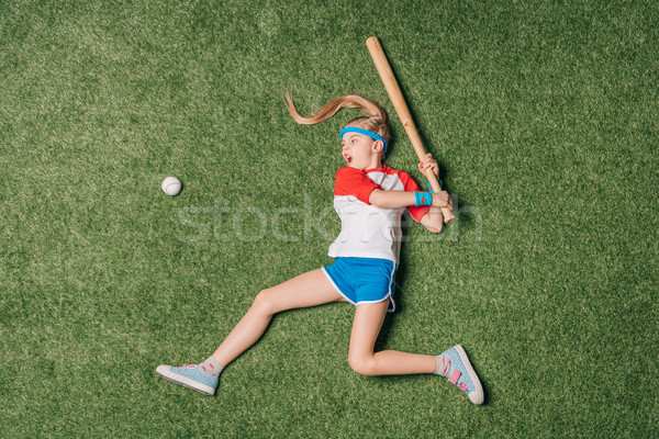top view of little girl pretending playing baseball on grass, athletics children concept Stock photo © LightFieldStudios