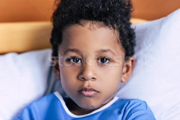 african american boy lying in bed Stock photo © LightFieldStudios