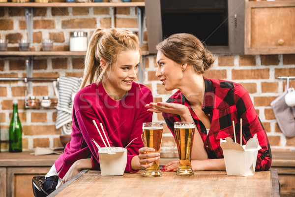 Happy women with noodles and beer Stock photo © LightFieldStudios