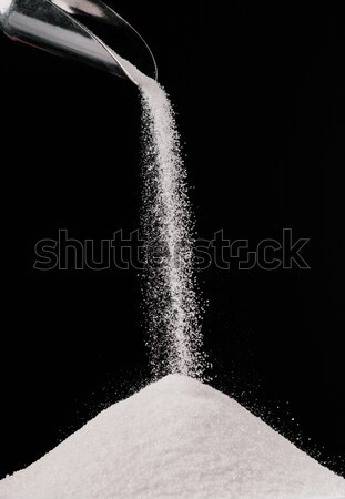 white sugar falling from metal scoop on pile isolated on black Stock photo © LightFieldStudios
