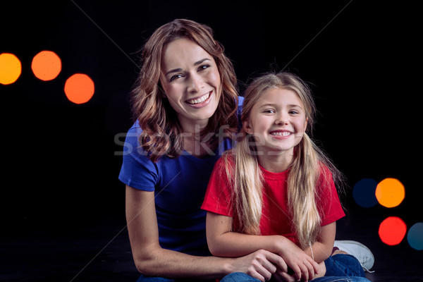 Mother and daughter smiling at camera Stock photo © LightFieldStudios