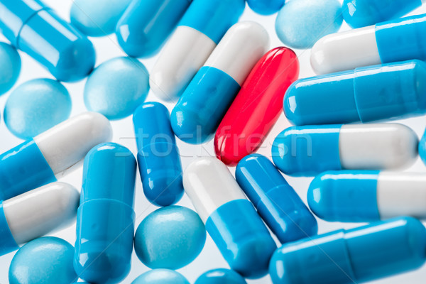 close up view of medical pills and capsules on white Stock photo © LightFieldStudios