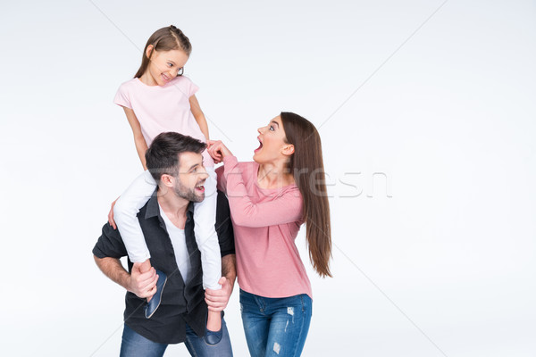 Happy young family with one child having fun together on white  Stock photo © LightFieldStudios