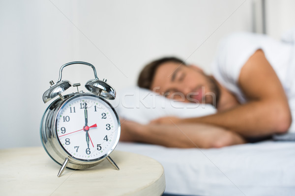 alarm clock on bedside table Stock photo © LightFieldStudios