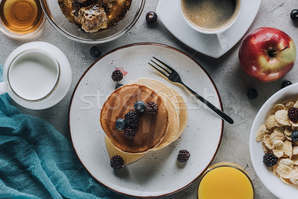 top view of tasty healthy breakfast with pancakes, fruits and granola on grey  Stock photo © LightFieldStudios