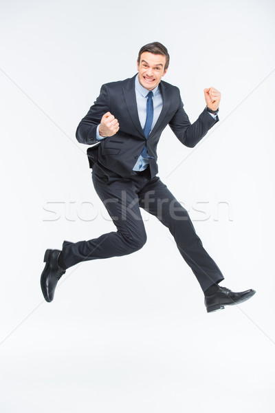 Jóvenes excitado empresario saltar blanco trabajo Foto stock © LightFieldStudios