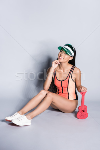 woman in swimsuit and visor with ukulele Stock photo © LightFieldStudios