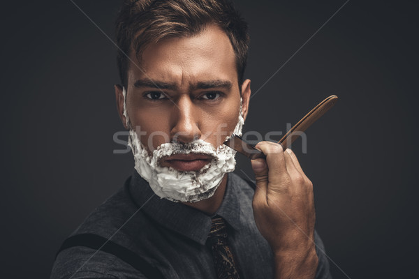 Férfi egyenes borotva fiatal jóképű férfi krém Stock fotó © LightFieldStudios