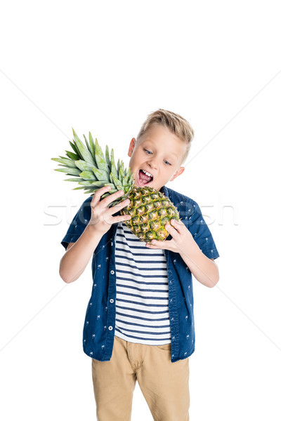 boy biting pineapple Stock photo © LightFieldStudios
