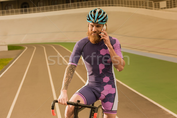 Stock photo: cyclist talking on smartphone