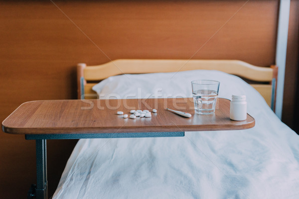 Tabletták hőmérő asztal üveg víz kórház Stock fotó © LightFieldStudios