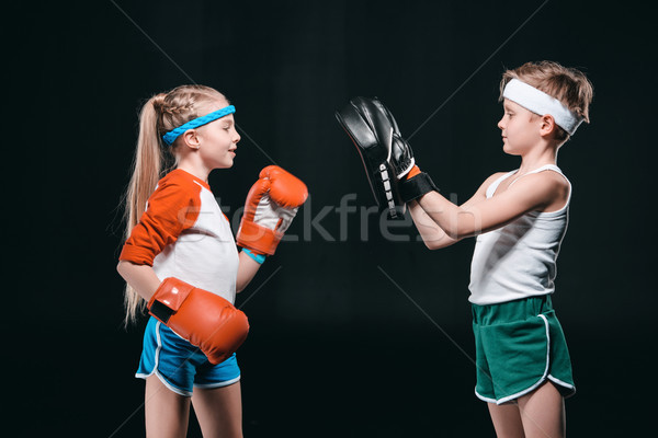 side view of kids pretending boxing isolated on black, active kids concept Stock photo © LightFieldStudios