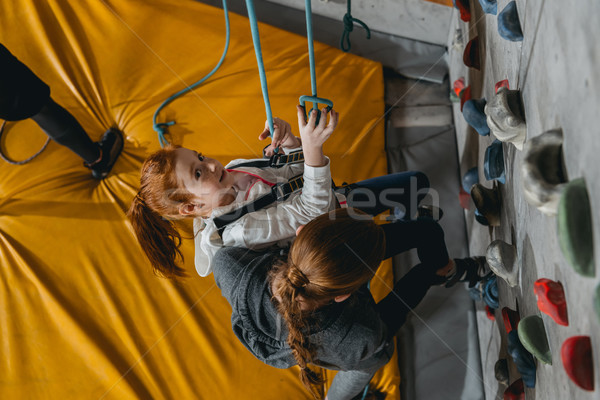 Little girl hanging on wall with grips Stock photo © LightFieldStudios