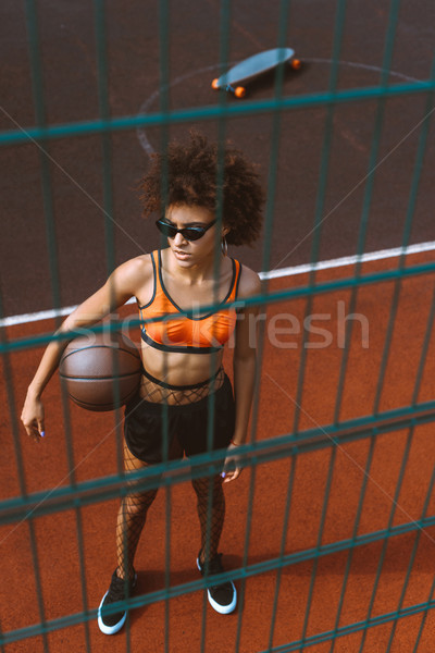 african-american woman holding basketball Stock photo © LightFieldStudios