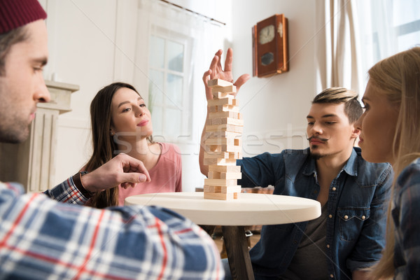 Vue de côté hommes femmes jouer jeu maison [[stock_photo]] © LightFieldStudios