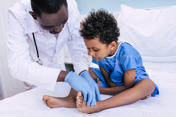 african american doctor examining patient Stock photo © LightFieldStudios