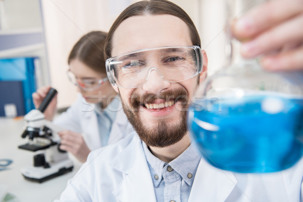 Scientist holding chemical reagent Stock photo © LightFieldStudios