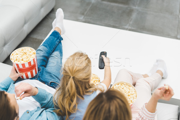 overhead view of family with popcorn watching tv together at home Stock photo © LightFieldStudios
