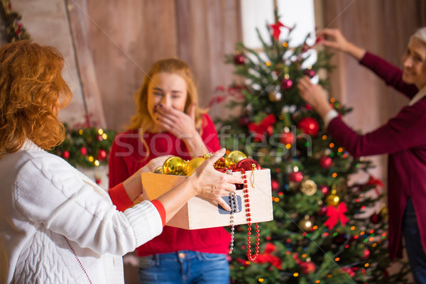 Family decorating christmas tree Stock photo © LightFieldStudios