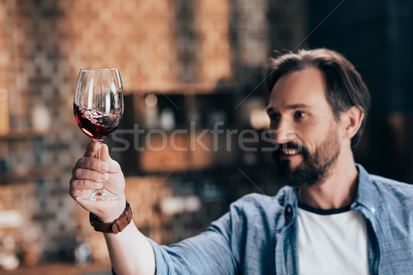man examining red wine Stock photo © LightFieldStudios