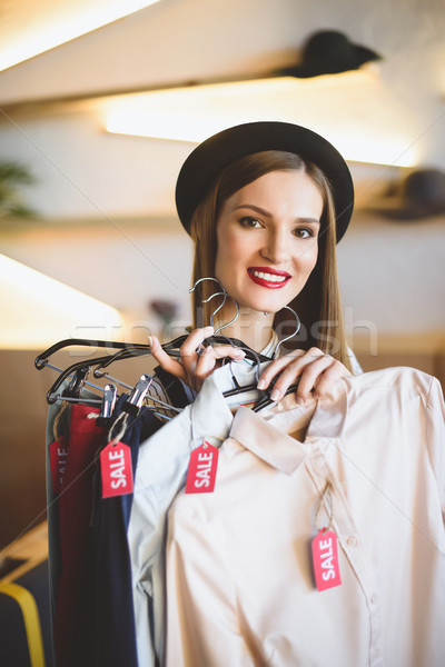Lány tart ruházat vásár címkék gyönyörű Stock fotó © LightFieldStudios