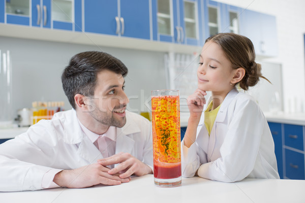 portrait of man teacher and girl student scientists making experiment in lab Stock photo © LightFieldStudios