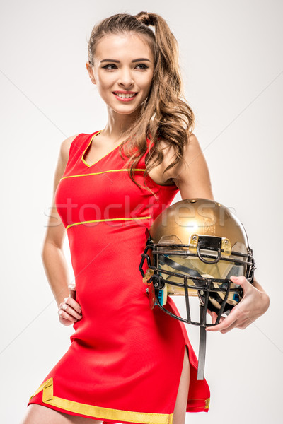 Stock photo: Cheerleader posing with helmet