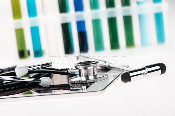 close up view of stethoscope on digital tablet and reflex hammer on white Stock photo © LightFieldStudios