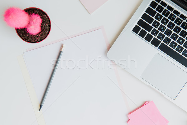 Stock photo: Top view of laptop, pencil and blank papers on table top, wireless communication concept