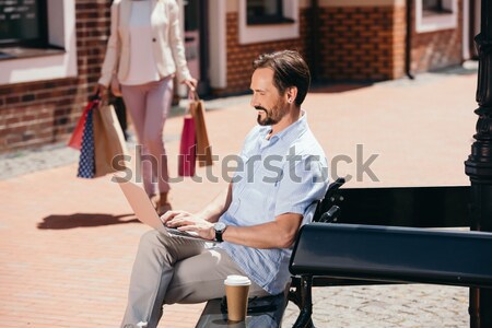 Woman leaning onto man on chair Stock photo © LightFieldStudios