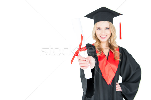 Close-up view of smiling student in graduation gown holding diploma on white   Stock photo © LightFieldStudios