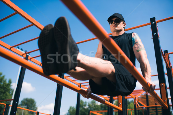 man exercising on sports ground Stock photo © LightFieldStudios