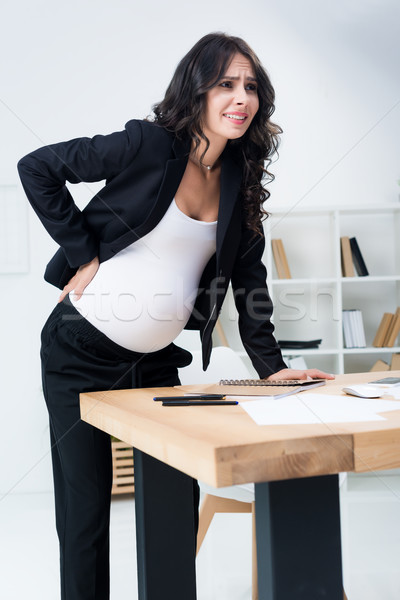 pregnant businesswoman with back pain Stock photo © LightFieldStudios