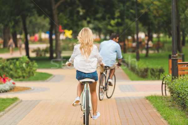 couple riding bicycles in park Stock photo © LightFieldStudios