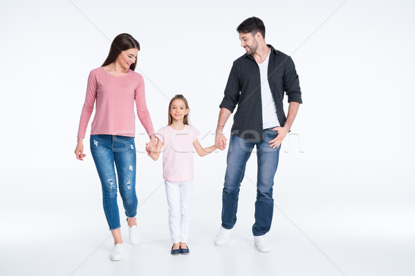 Happy young family with one child holding hands on white Stock photo © LightFieldStudios