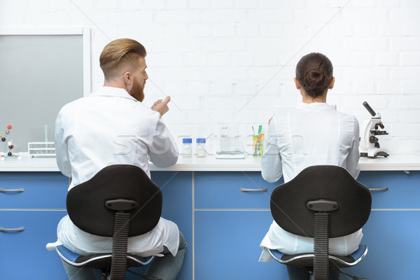 back view of scientists discussing analysis during work in lab Stock photo © LightFieldStudios