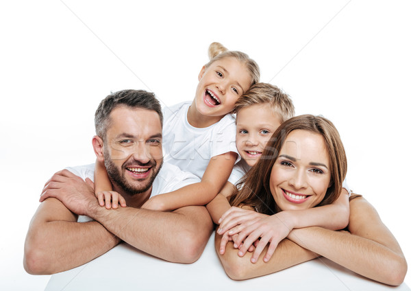 Smiling family in white t-shirts hugging  Stock photo © LightFieldStudios