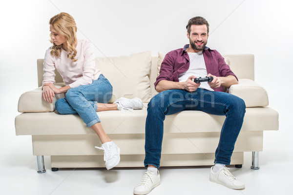 Offended woman and man playing with joystick Stock photo © LightFieldStudios