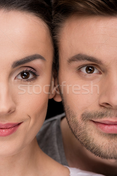 headshot of smiling woman and man looking to camera on black Stock photo © LightFieldStudios
