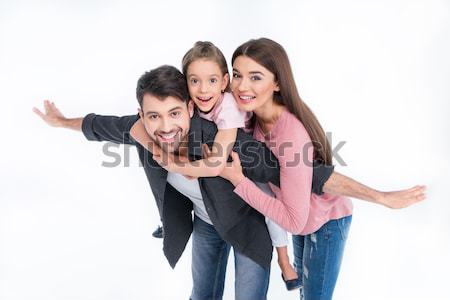 Happy young family with one child having fun together on white Stock photo © LightFieldStudios