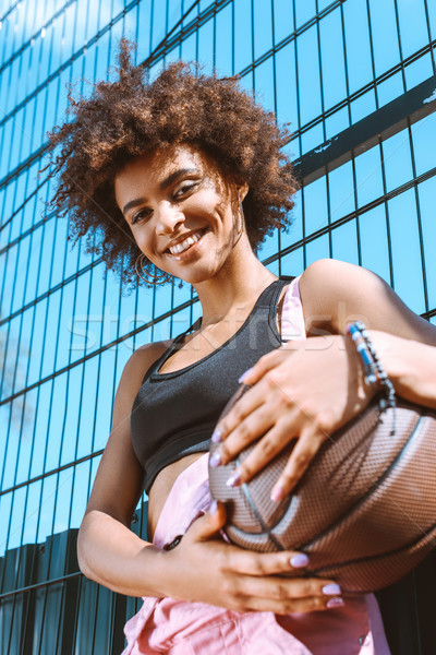 Stock photo: african-american woman holding basketball