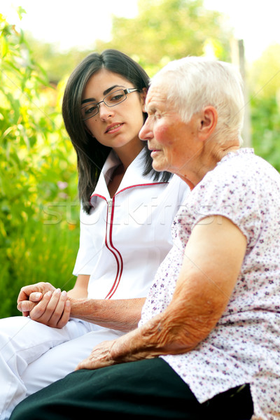 Gondoskodó fiatal orvos nővér idős beteg Stock fotó © Lighthunter