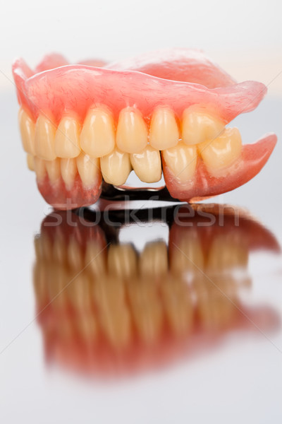Dental prosthesis on mirror surface Stock photo © Lighthunter