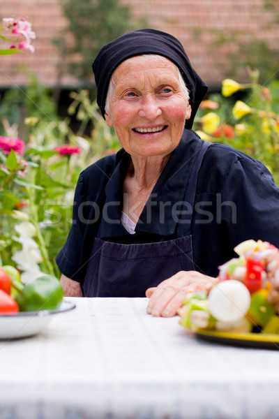 Idős nő asztal ül étel nevet nő Stock fotó © Lighthunter