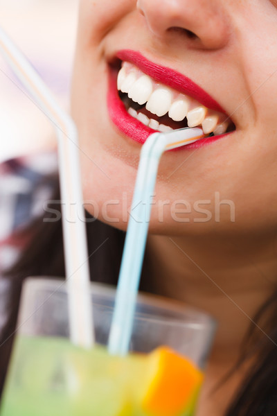 Smiling young woman with cocktail Stock photo © Lighthunter