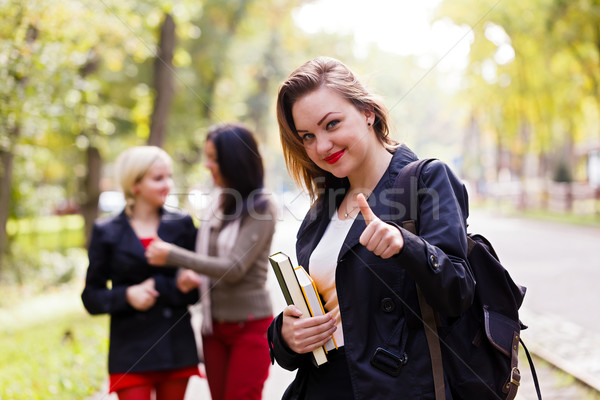 Stock photo: Schoolgirl showing thubsup