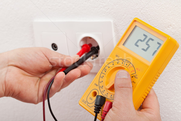 Checking voltage in a wall fixture Stock photo © lightkeeper