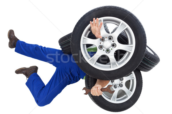 Mechanic covered by car tires Stock photo © lightkeeper