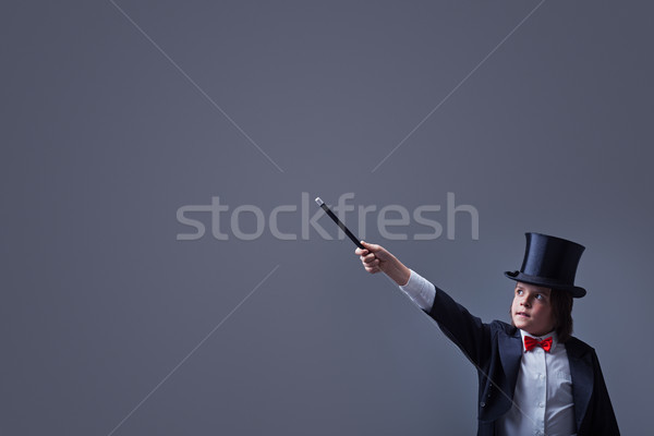 Magician boy with hardhat pointing to copy space with magic wand Stock photo © lightkeeper
